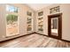 Bright, naturally lit room with wood-look floors featuring large windows and a door to the deck at 15175 Rainbow Dr, Sedalia, CO 80135