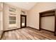 Spacious, naturally lit room with wood-look flooring, large windows, and a closet at 15175 Rainbow Dr, Sedalia, CO 80135