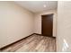 Room with neutral paint, dark stained trim and a door at 15175 Rainbow Dr, Sedalia, CO 80135