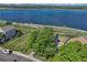 Lakeside aerial view features home, fenced yard, and tranquil blue water backdrop at 1353 Mallard Ln, Brighton, CO 80601