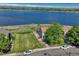 Aerial view of home and property featuring a fenced backyard and lakeside view at 1353 Mallard Ln, Brighton, CO 80601