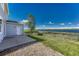 Backyard featuring lake views and a well-maintained lawn at 1353 Mallard Ln, Brighton, CO 80601