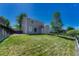 Backyard with a well-maintained lawn, partial fence, and a view of the home's exterior at 1353 Mallard Ln, Brighton, CO 80601