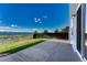 Backyard offers lake views, a green lawn, and a concrete patio at 1353 Mallard Ln, Brighton, CO 80601