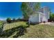 Fenced backyard features an expanse of lawn, and a well-maintained home exterior at 1353 Mallard Ln, Brighton, CO 80601