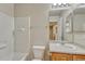 Bathroom featuring a tub, a toilet, and vanity with a large mirror at 1353 Mallard Ln, Brighton, CO 80601
