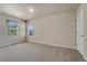 Bedroom with neutral carpet, neutral walls, and two windows at 1353 Mallard Ln, Brighton, CO 80601
