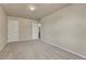 Bedroom with neutral carpet, neutral walls, and two doors at 1353 Mallard Ln, Brighton, CO 80601