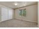 Bedroom with neutral carpet, neutral walls, a window, and closet at 1353 Mallard Ln, Brighton, CO 80601