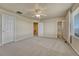 Large bedroom with soft carpet, a ceiling fan, and multiple doors at 1353 Mallard Ln, Brighton, CO 80601