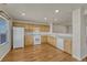 Bright kitchen with wooden cabinets, white appliances, and hardwood floors offers plenty of storage at 1353 Mallard Ln, Brighton, CO 80601