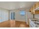 Kitchen area with wooden cabinets, white appliances, and hardwood floors at 1353 Mallard Ln, Brighton, CO 80601
