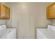 Laundry room with white appliances and neutral paint at 1353 Mallard Ln, Brighton, CO 80601