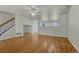 Open-concept living area with hardwood floors, bright lighting and adjacent stairway at 1353 Mallard Ln, Brighton, CO 80601