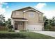 Charming two-story home with a large two-car garage and manicured lawn at 48235 Shetland Dr, Bennett, CO 80102