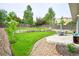 Lush backyard with a well-maintained lawn, a patio area, and mature trees, ideal for outdoor activities at 5532 S Valdai Way, Aurora, CO 80015