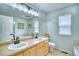 Bright bathroom with double vanity, bathtub, and large mirror providing ample natural light at 5532 S Valdai Way, Aurora, CO 80015