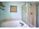 Clean bathroom featuring a soaking tub and a separate shower with glass doors at 5532 S Valdai Way, Aurora, CO 80015