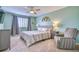 Cozy bedroom with a gray upholstered bed, ceiling fan, and window with gray curtains at 5532 S Valdai Way, Aurora, CO 80015