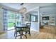 Modern dining room featuring an open floor plan, a sliding glass door, and stylish light fixture at 5532 S Valdai Way, Aurora, CO 80015