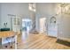 Bright foyer with a view of the stairs, dining room, and a white console table with decorative mirror at 5532 S Valdai Way, Aurora, CO 80015
