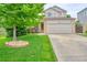 Charming two-story home with a well-manicured lawn and a large tree in the front yard at 5532 S Valdai Way, Aurora, CO 80015