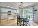 Modern kitchen features stainless steel appliances, white cabinets, and a dining area with a sliding glass door at 5532 S Valdai Way, Aurora, CO 80015