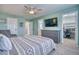 Spacious main bedroom offering closet, ensuite bathroom, and large mounted television at 5532 S Valdai Way, Aurora, CO 80015