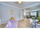 Playroom adjacent to living room, featuring light gray walls and hardwood floors at 5532 S Valdai Way, Aurora, CO 80015