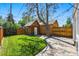 Backyard featuring a manicured lawn, shed, and patio at 1612 S Logan St, Denver, CO 80210