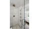 Bathroom showcasing a glass door shower with marble tile and built-in shelves at 1612 S Logan St, Denver, CO 80210