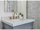 Bathroom featuring a gray vanity with gold fixtures and a marble countertop at 1612 S Logan St, Denver, CO 80210
