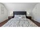Bedroom with a gray upholstered headboard and patterned bedding at 1612 S Logan St, Denver, CO 80210