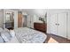 Bedroom with a brick accent wall, closet, and a bathroom at 1612 S Logan St, Denver, CO 80210