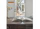 Desk in the home with a light and open book, and a door leading to the yard at 1612 S Logan St, Denver, CO 80210