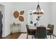 Stylish dining area with decorative wall art, bar cart, and open access to the outdoors at 1612 S Logan St, Denver, CO 80210