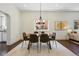 Elegant dining room with modern lighting, wood table, and view into other rooms at 1612 S Logan St, Denver, CO 80210