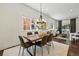 Charming dining room with modern chandelier, wooden table, and comfortable seating at 1612 S Logan St, Denver, CO 80210