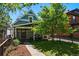 Charming home with a well-manicured lawn, mature tree, and inviting front porch at 1612 S Logan St, Denver, CO 80210