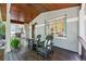 Inviting front porch with rocking chairs, wood ceiling, and decorative fern accents at 1612 S Logan St, Denver, CO 80210