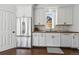 This kitchen features white cabinets, wood countertops, stainless steel appliances, and a view to the outdoors at 1612 S Logan St, Denver, CO 80210