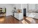 Spacious kitchen with white cabinets, wood countertops, stainless steel appliances, and hardwood floors at 1612 S Logan St, Denver, CO 80210