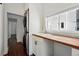 Bright laundry area with white cabinets, wood countertop, stackable washer/dryer, and a view to the outdoors at 1612 S Logan St, Denver, CO 80210