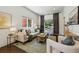 Bright and airy living room with hardwood floors, neutral tones, and large windows at 1612 S Logan St, Denver, CO 80210