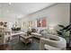 Bright living room with modern furnishings and ample natural light, open to dining area at 1612 S Logan St, Denver, CO 80210