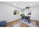 Bright home office with hardwood floors, modern desk, ceiling fan, and a view to the outdoors at 1612 S Logan St, Denver, CO 80210