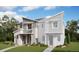 A modern two-story townhome featuring stone and lap siding, a well-manicured lawn, and an attached two-car garage at 22813 E Tufts Ave # A, Aurora, CO 80015