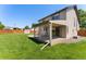 Large backyard boasts a covered patio, lush lawn, and privacy fence at 12814 Forest Cir, Thornton, CO 80241