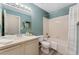 Well-lit bathroom with a tub/shower, teal walls, and bright white vanity at 12814 Forest Cir, Thornton, CO 80241