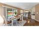 Cozy dining room with sliding doors to the backyard and an open view into the modern kitchen at 12814 Forest Cir, Thornton, CO 80241